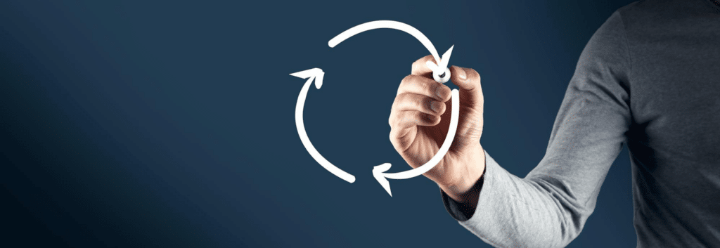 A hand drawing a recycling icon, symbolizing a continuous cycle