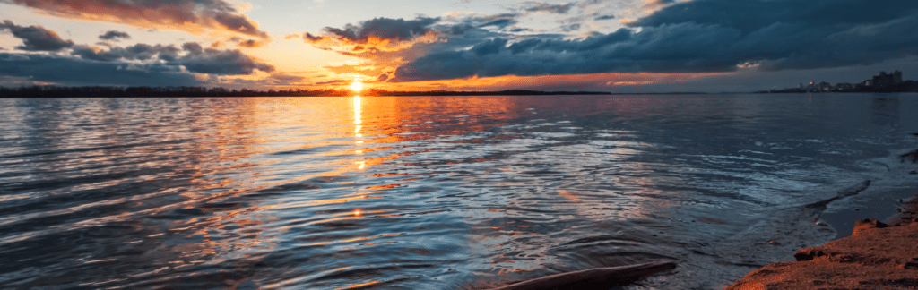 A landscape image of a sunset on a lake to represent the post titled big datasec a checklist for securing data lakes
