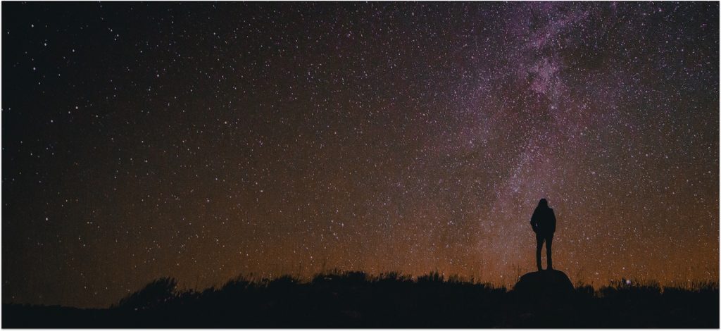 A man standing in front of milky way to pair with the post titled infrastructure orchestration 
