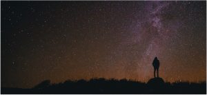 A man standing in front of milky way to pair with the post titled infrastructure orchestration