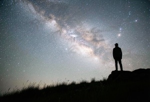 A man standing in front of milky way to pair with the post titled infrastructure orchestration