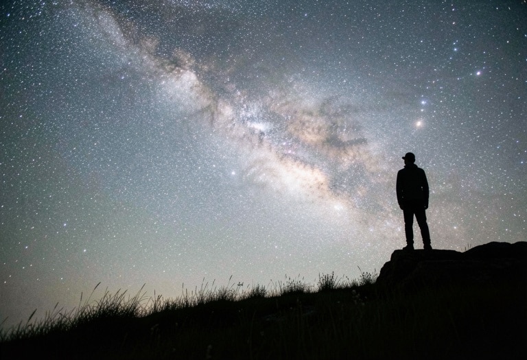 A man standing in front of milky way to pair with the post titled infrastructure orchestration 